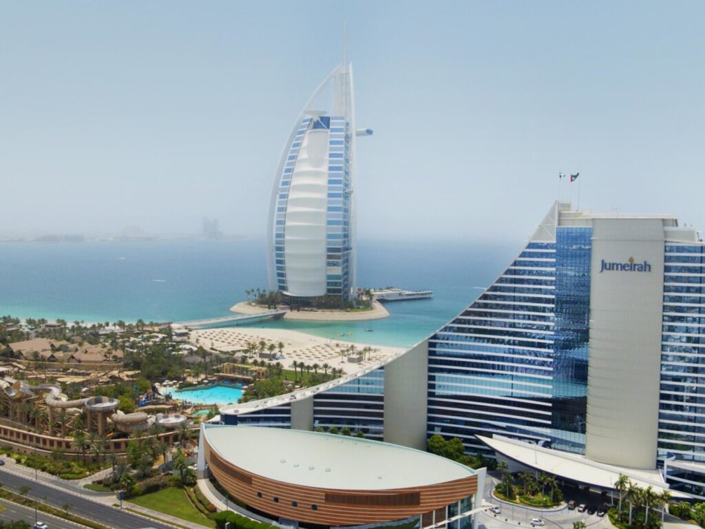 Burj Al Arab and Jumeirah Beach Hotel by the sea in Dubai.