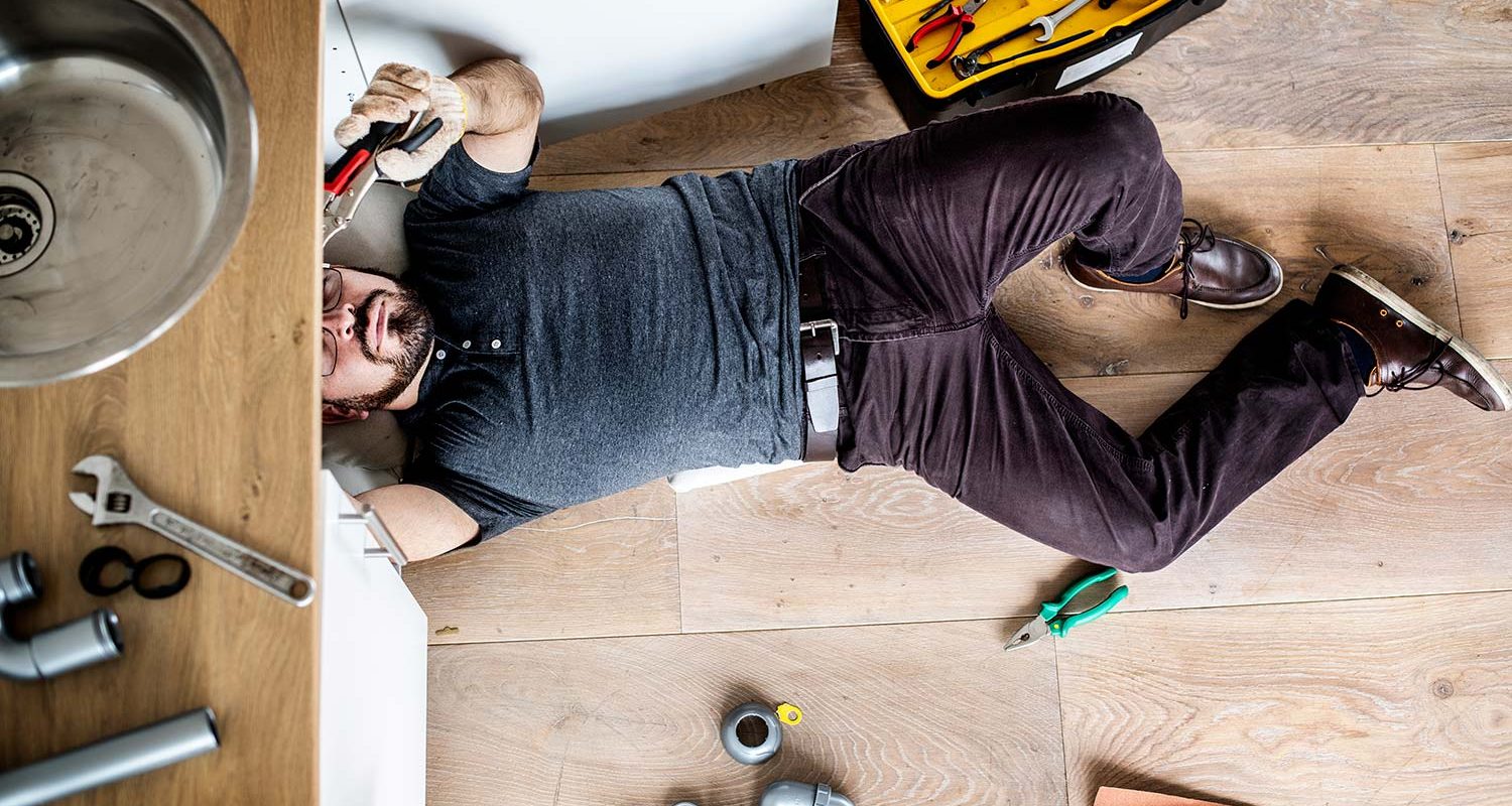man fixing kitchen sink
